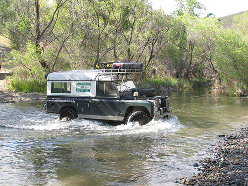Land Rover Dormobile crossing a stream